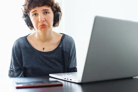 Discouraged young woman in front of her laptop